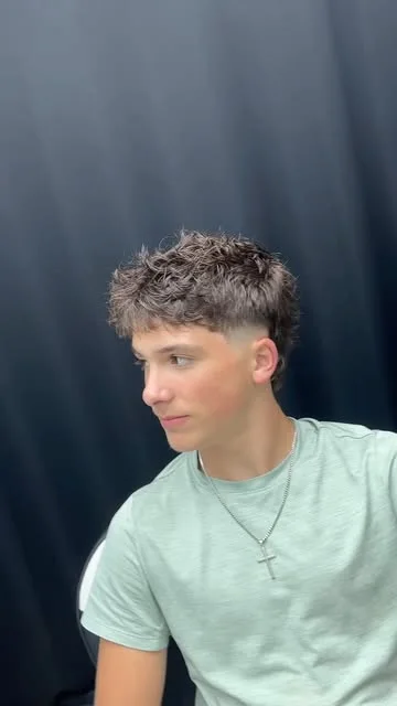 Finished burst fade with textured hair on top