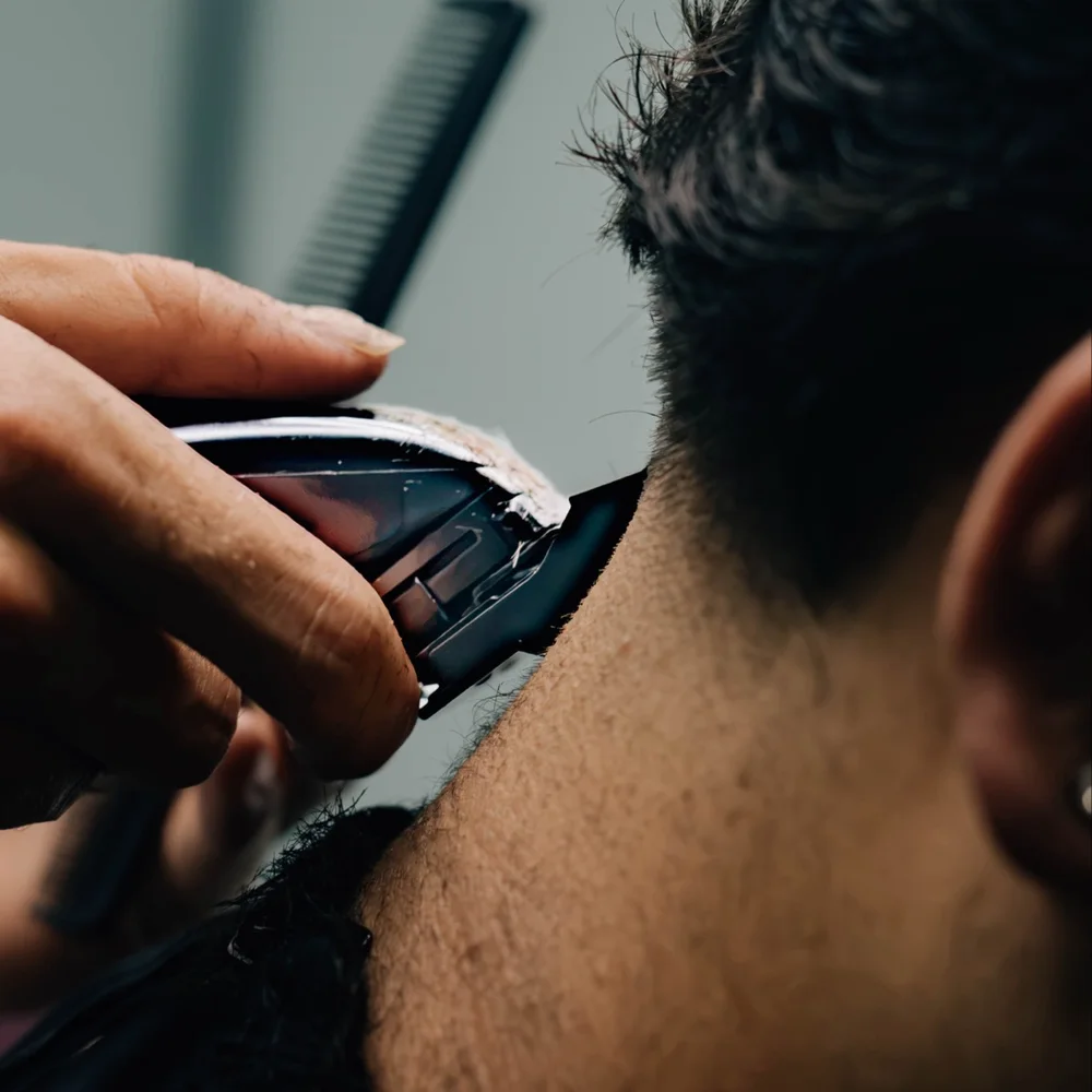 Caleb refining the hairline with clippers
