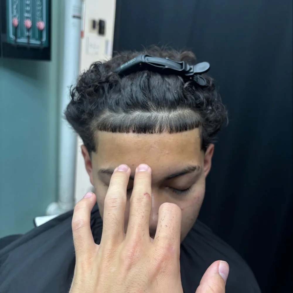 Straight line up on a curly haircut by Caleb